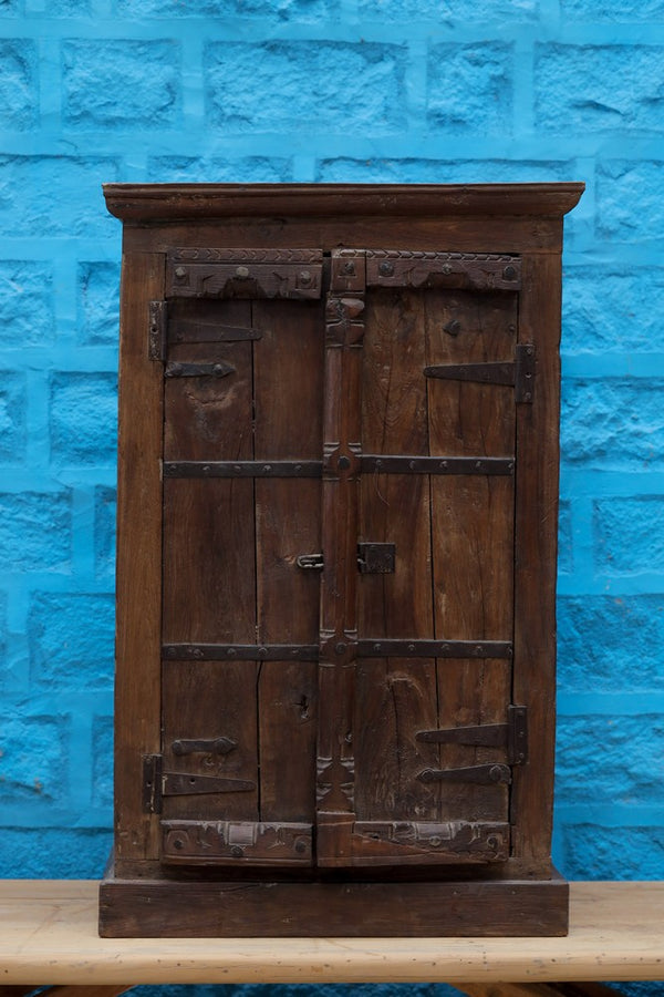Traditional Carved Brown Wooden Cabinet with Intricate Detailing